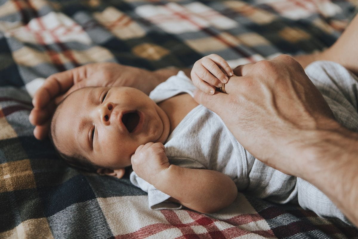 yawning-baby-lying-on-back